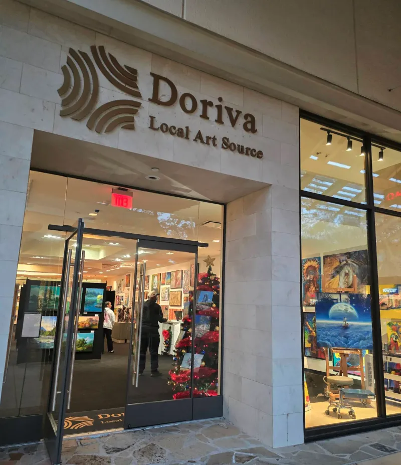 Doriva Local Art Source wide entrance view with customers browsing and seasonal displays alongside original artwork