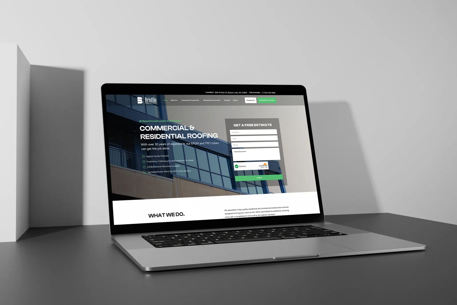 Bristlin Construction Services redesigned website displayed on a MacBook laptop, showing the professional dark theme with commercial roofing hero section and estimate form
