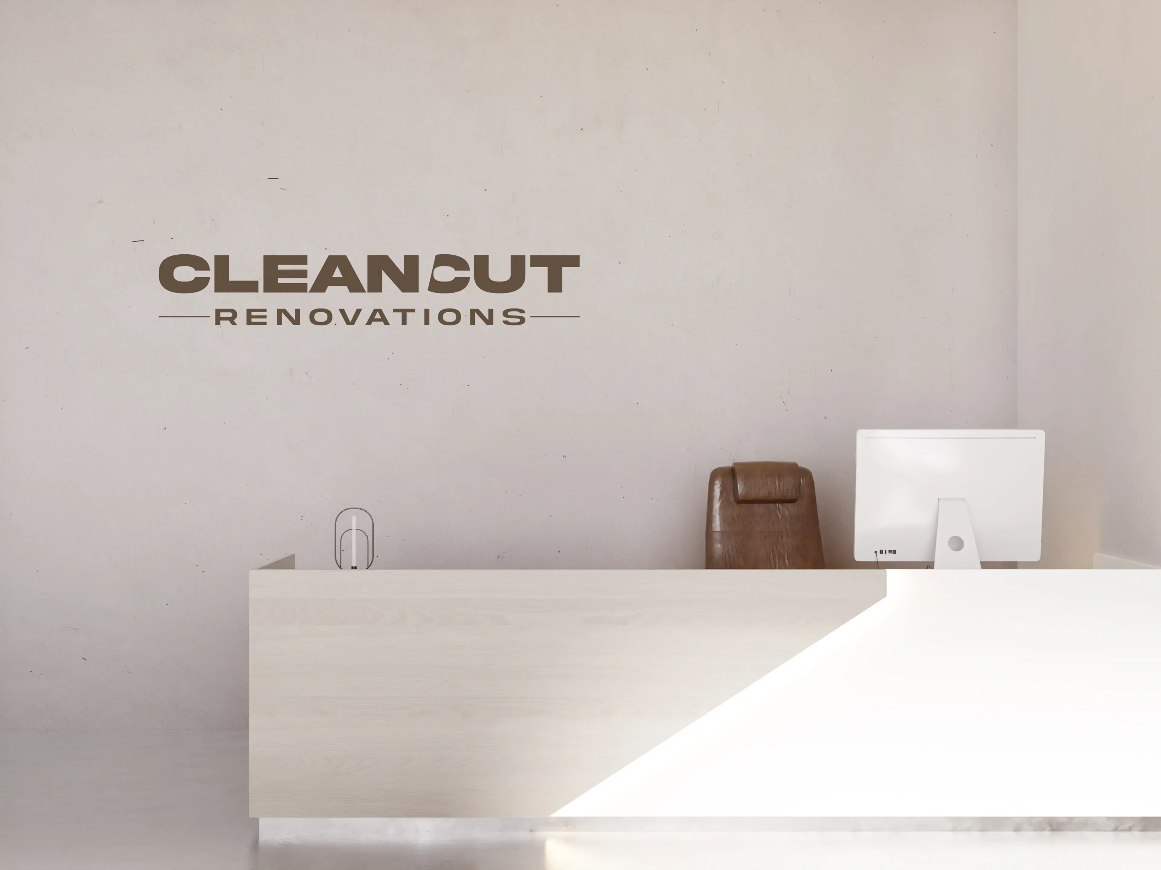 Clean Cut Renovations logo mounted on office wall above a minimalist reception desk